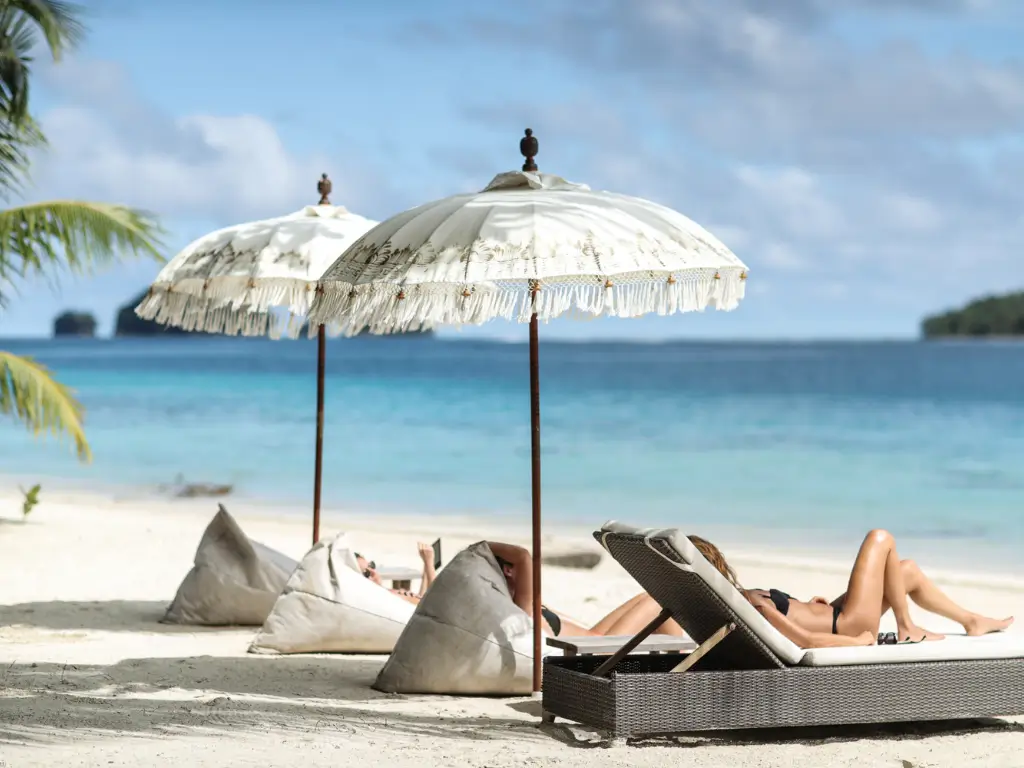 poeple suntanning on the pristine beach at aloit aresort